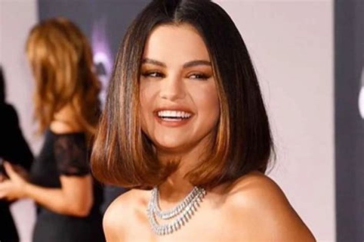 Selena Gomez Stuns In Acid Green Versace Mini Dress As She Walks The American Music Awards Red Carpet